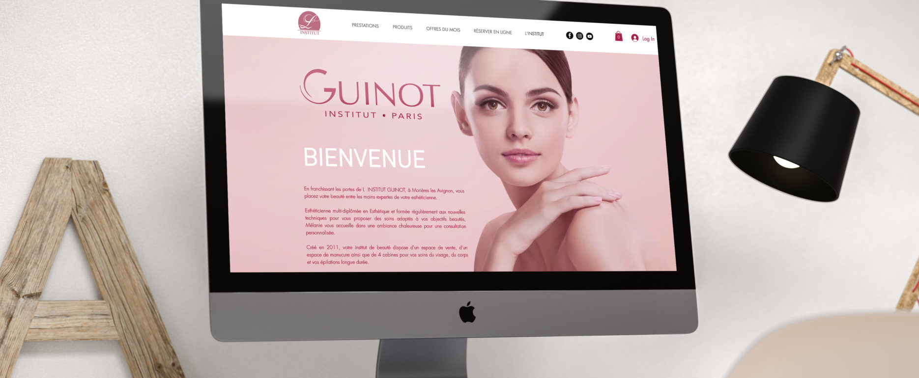 iMac posé sur un bureau et allumé avec la page internet du site de l'Institut Guinot